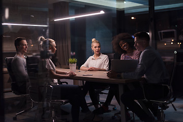 Image showing Multiethnic startup business team in night office