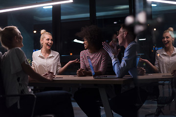 Image showing Multiethnic startup business team in night office