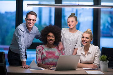 Image showing Multiethnic startup business team in night office