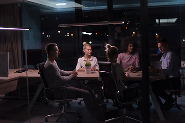 Image showing Multiethnic startup business team in night office