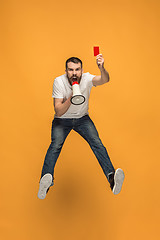 Image showing Football supporter with red card on orange background