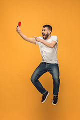 Image showing Football supporter with red card on orange background