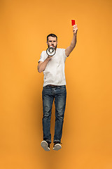 Image showing Football supporter with red card on orange background