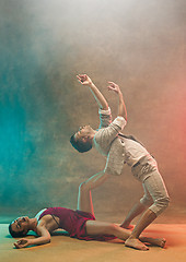 Image showing Flexible young modern dance couple posing in studio.