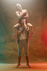 Image showing Flexible young modern dance couple posing in studio.