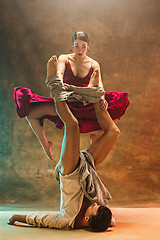 Image showing Flexible young modern dance couple posing in studio.