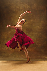 Image showing Young ballet dancer - Harmonious pretty woman with tutu posing in studio -