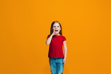 Image showing Isolated on pink young casual teen girl shouting at studio