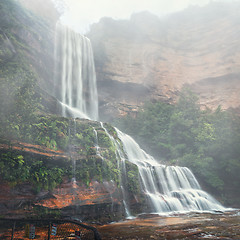 Image showing Misty waterfalls tumble down cliffs