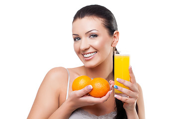 Image showing Beautiful girl with oranges and orange juice