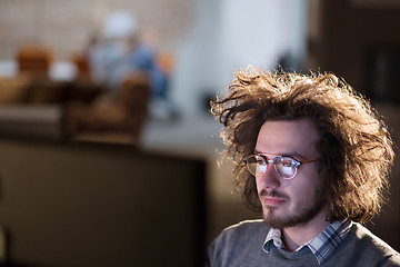 Image showing man working on computer in dark office