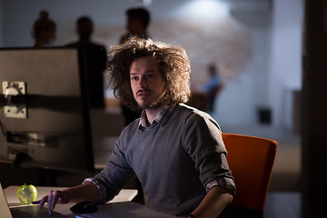 Image showing man working on computer in dark office