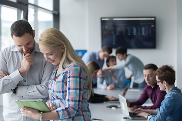 Image showing Two Business People Working With Tablet in office