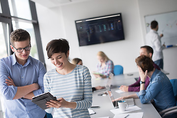 Image showing Two Business People Working With Tablet in office