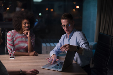 Image showing Multiethnic startup business team in night office