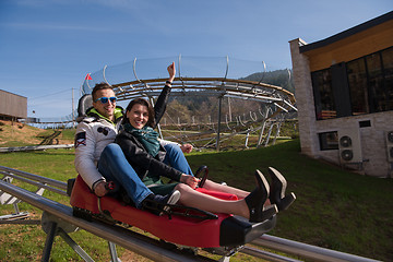 Image showing couple enjoys driving on alpine coaster