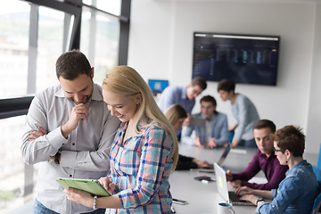 Image showing Two Business People Working With Tablet in office