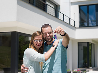 Image showing couple hugging in front of  new luxury home