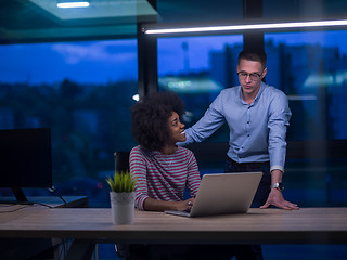 Image showing Multiethnic startup business team in night office