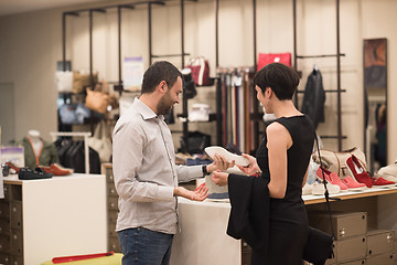Image showing couple chooses shoes At Shoe Store