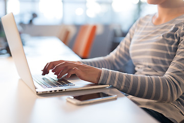 Image showing businesswoman using a laptop in startup office