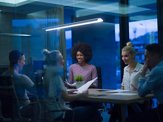 Image showing Multiethnic startup business team in night office