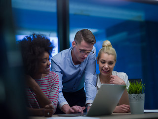 Image showing Multiethnic startup business team in night office