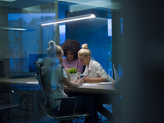 Image showing Multiethnic startup business team in night office