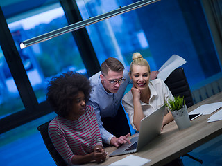 Image showing Multiethnic startup business team in night office