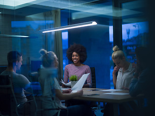 Image showing Multiethnic startup business team in night office