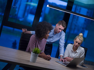 Image showing Multiethnic startup business team in night office