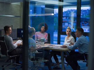 Image showing Multiethnic startup business team in night office