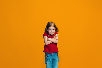 Image showing Beautiful teen girl looking suprised and bewildered isolated on orange