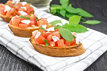 Image showing Bruschetta with tomato and feta on board