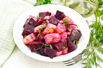 Image showing Salad of beets and potatoes in plate on wooden board