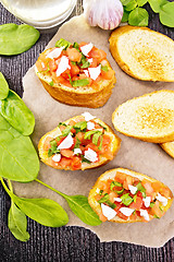Image showing Bruschetta with tomato and cheese on board top