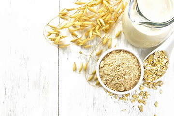 Image showing Flour oat in bowl with milk on board top