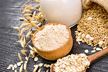 Image showing Flour oat in bowl with oatmeal on wooden board