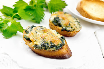 Image showing Sandwich of nettle and cheese on light board