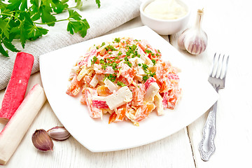 Image showing Salad of surimi and tomatoes with mayonnaise on light board