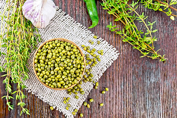 Image showing Mung beans in wooden bowl with thyme on board top