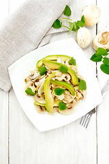 Image showing Salad of avocado and champignons on light board top