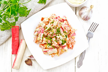 Image showing Salad of surimi and tomatoes with mayonnaise on light board top