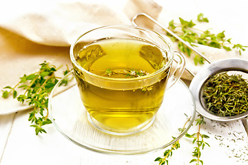 Image showing Tea of thyme in cup on light board