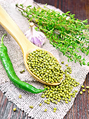 Image showing Mung beans in spoon on dark board