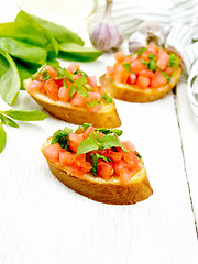 Image showing Bruschetta with tomato and spinach on white board