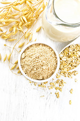 Image showing Flour oat in bowl with milk on white board top