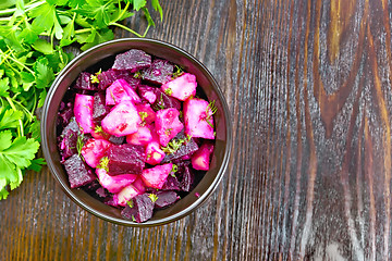 Image showing Salad of beets and potatoes with oil in bowl on board top