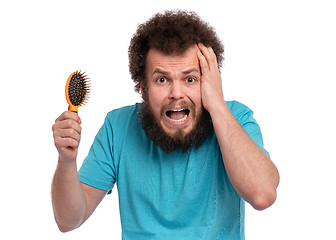 Image showing Crazy bearded man with hairbrush