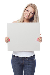 Image showing Beautiful blond girl holding blank poster